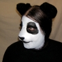 Man wearing foam latex prosthetic nose and makeup to look like an anthropomorphic panda Man wearing foam latex prosthetic nose and makeup to look like an anthropomorphic panda