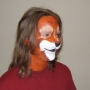 Man wearing foam latex prosthetic nose and makeup to look like an anthropomorphic brown squirrel.
