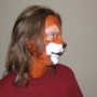 Man wearing foam latex prosthetic nose and makeup to look like an anthropomorphic brown squirrel.