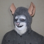 Man wearing foam latex prosthetic nose and makeup to look like an anthropomorphic grey rat.
