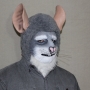 Man wearing foam latex prosthetic nose and makeup to look like an anthropomorphic grey rat.