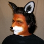 Man wearing latex prosthetic nose and makeup to look like an anthropomorphic fox.