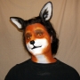 Man wearing latex prosthetic nose and makeup to look like an anthropomorphic fox.