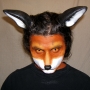 Man wearing latex prosthetic nose and makeup to look like an anthropomorphic fox.