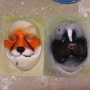 Two Small Fox Nose slush cast latex prosthetics placed on a plastic human face cast, painted as a fox and a skunk