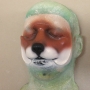 Small Fox Nose foam latex prosthetic placed on a plastic human face cast, painted as a red-brown fox
