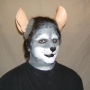 Man wearing foam latex prosthetic nose and makeup to look like an anthropomorphic grey rat.