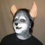 Man wearing foam latex prosthetic nose and makeup to look like an anthropomorphic grey rat.