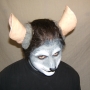Man wearing foam latex prosthetic nose and makeup to look like an anthropomorphic grey rat.