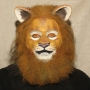 Man wearing foam latex prosthetic nose and makeup to look like an anthropomorphic tan lion.