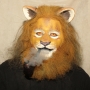 Man wearing foam latex prosthetic nose and makeup to look like an anthropomorphic tan lion.