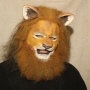 Man wearing foam latex prosthetic nose and makeup to look like an anthropomorphic tan lion.