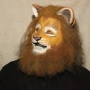 Man wearing foam latex prosthetic nose and makeup to look like an anthropomorphic tan lion.