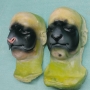 Two foam latex prosthetic Sheep / Goat Noses painted dark grey and black placed on plastic human face casts. One has a pink nose. Two foam latex prosthetic Sheep / Goat Noses painted dark grey and black placed on plastic human face casts. One has a pink nose.