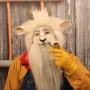 Man wearing foam latex prosthetic nose and makeup to look like an anthropomorphic white goat smoking a pipe. Man wearing foam latex prosthetic nose and makeup to look like an anthropomorphic white goat smoking a pipe.
