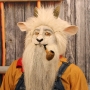 Man wearing foam latex prosthetic nose and makeup to look like an anthropomorphic white goat smoking a pipe. Man wearing foam latex prosthetic nose and makeup to look like an anthropomorphic white goat smoking a pipe.