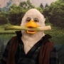 Man wearing foam latex prosthetic face and makeup to look like an anthropomorphic duck, holding a leek in mouth Man wearing foam latex prosthetic face and makeup to look like an anthropomorphic duck, holding a leek in mouth
