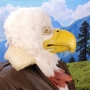 Man wearing latex prosthetic beak and makeup with feathers to look like an anthropomorphic bald eagle.