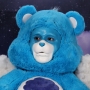 Man wearing latex prosthetic nose and makeup to look like an anthropomorphic Grumpy Bear.