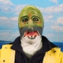 Man wearing foam latex prosthetic face and makeup to look like an anthropomorphic salmon.