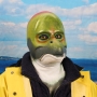 Man wearing foam latex prosthetic face and makeup to look like an anthropomorphic salmon.