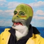 Man wearing foam latex prosthetic face and makeup to look like an anthropomorphic salmon.