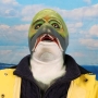 Man wearing foam latex prosthetic face and makeup to look like an anthropomorphic salmon.
