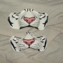 Two Latex Wild Cat Noses painted as white tigers placed on a cloth