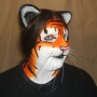 Man wearing foam latex prosthetic nose and makeup to look like an anthropomorphic orange tiger. Man wearing foam latex prosthetic nose and makeup to look like an anthropomorphic orange tiger.