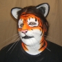 Man wearing foam latex prosthetic nose and makeup to look like an anthropomorphic orange tiger. Man wearing foam latex prosthetic nose and makeup to look like an anthropomorphic orange tiger.