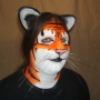 Man wearing foam latex prosthetic nose and makeup to look like an anthropomorphic orange tiger. Man wearing foam latex prosthetic nose and makeup to look like an anthropomorphic orange tiger.