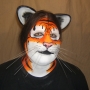 Man wearing foam latex prosthetic nose and makeup to look like an anthropomorphic orange tiger. Man wearing foam latex prosthetic nose and makeup to look like an anthropomorphic orange tiger.