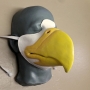 Slush cast latex prosthetic eagle beak placed on a plastic human face cast wiht a strap and painted as an eagle