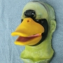 Foam Latex prosthetic Small Duck Bill placed on a plastic human face cast, painted in yellow and black.