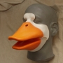 Foam Latex prosthetic Small Duck Bill placed on a plastic human face cast, painted in orange and white.