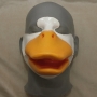 Foam Latex prosthetic Small Duck Bill placed on a plastic human face cast, painted in orange and white.