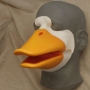 Foam Latex prosthetic Small Duck Bill placed on a plastic human face cast, painted in orange and white.