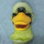 Foam Latex prosthetic Small Duck Bill placed on a plastic human face cast, painted in yellow and black.