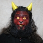 Man wearing foam latex prosthetic nose and makeup to look like a red demonic goat with gold eyes Man wearing foam latex prosthetic nose and makeup to look like a red demonic goat with gold eyes
