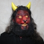 Man wearing foam latex prosthetic nose and makeup to look like a red demonic goat with gold eyes Man wearing foam latex prosthetic nose and makeup to look like a red demonic goat with gold eyes