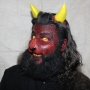 Man wearing foam latex prosthetic nose and makeup to look like a red demonic goat with gold eyes Man wearing foam latex prosthetic nose and makeup to look like a red demonic goat with gold eyes