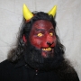 Man wearing foam latex prosthetic nose and makeup to look like a red demonic goat with gold eyes Man wearing foam latex prosthetic nose and makeup to look like a red demonic goat with gold eyes