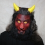 Man wearing foam latex prosthetic nose and makeup to look like a red demonic goat with gold eyes Man wearing foam latex prosthetic nose and makeup to look like a red demonic goat with gold eyes