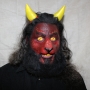 Man wearing foam latex prosthetic nose and makeup to look like a red demonic goat with gold eyes Man wearing foam latex prosthetic nose and makeup to look like a red demonic goat with gold eyes
