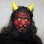 Man wearing foam latex prosthetic nose and makeup to look like a red demonic goat with gold eyes Man wearing foam latex prosthetic nose and makeup to look like a red demonic goat with gold eyes