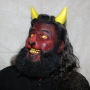 Man wearing foam latex prosthetic nose and makeup to look like a red demonic goat with gold eyes Man wearing foam latex prosthetic nose and makeup to look like a red demonic goat with gold eyes