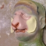 a foam latex prosthetic Sheep / Goat Nose painted in pink and light yellow alpaca placed on a plastic human face cast a foam latex prosthetic Sheep / Goat Nose painted in pink and light yellow alpaca placed on a plastic human face cast